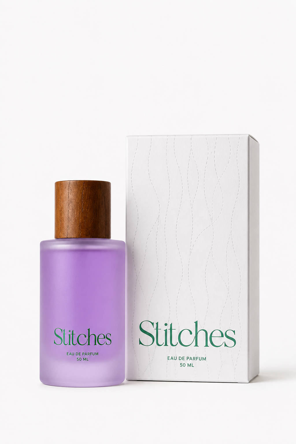 A bottle of Stitches Eau de Parfum with a translucent lavender-purple body and a wooden cap, standing next to its white packaging box with green 'Stitches' branding.